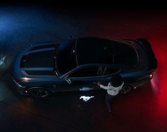 2024 Ford Mustang® Dark Horse™ model with a driver approaching the vehicle | Plantation Ford in Plantation FL