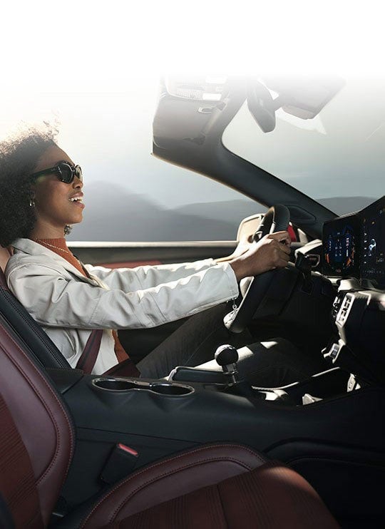 Person sitting in the driver’s seat of a 2024 Ford Mustang® convertible | Plantation Ford in Plantation FL